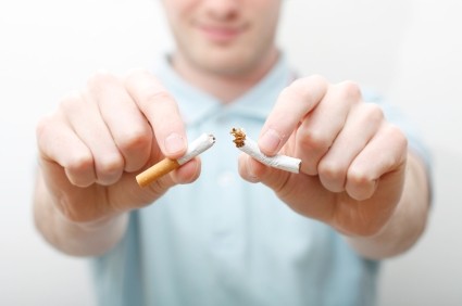 man breaking a cigarette into two